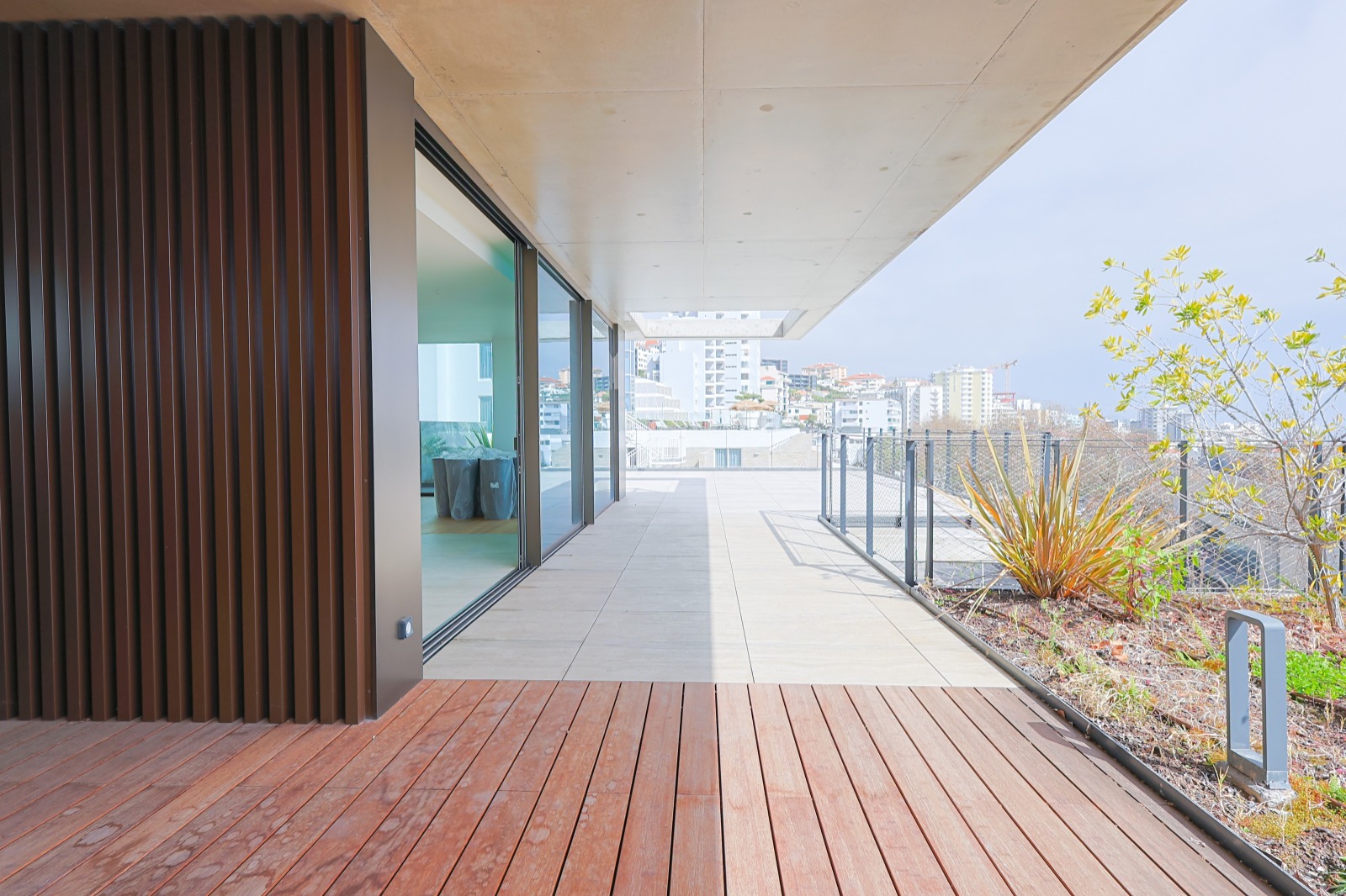 Covered terrace with wooden deck and city and sea views, Savoy Residence Monumentalis, Funchal