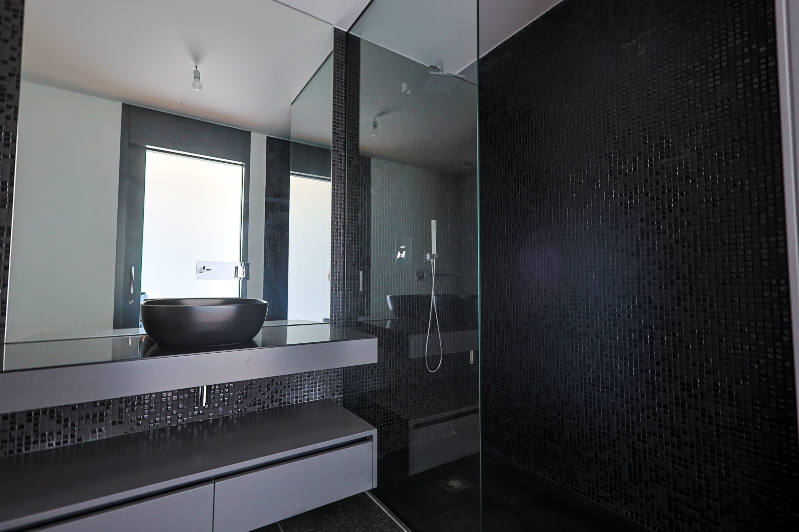 Bathroom with walk-in shower, black mosaic tiling and stone washbasin, Varino 07, Funchal