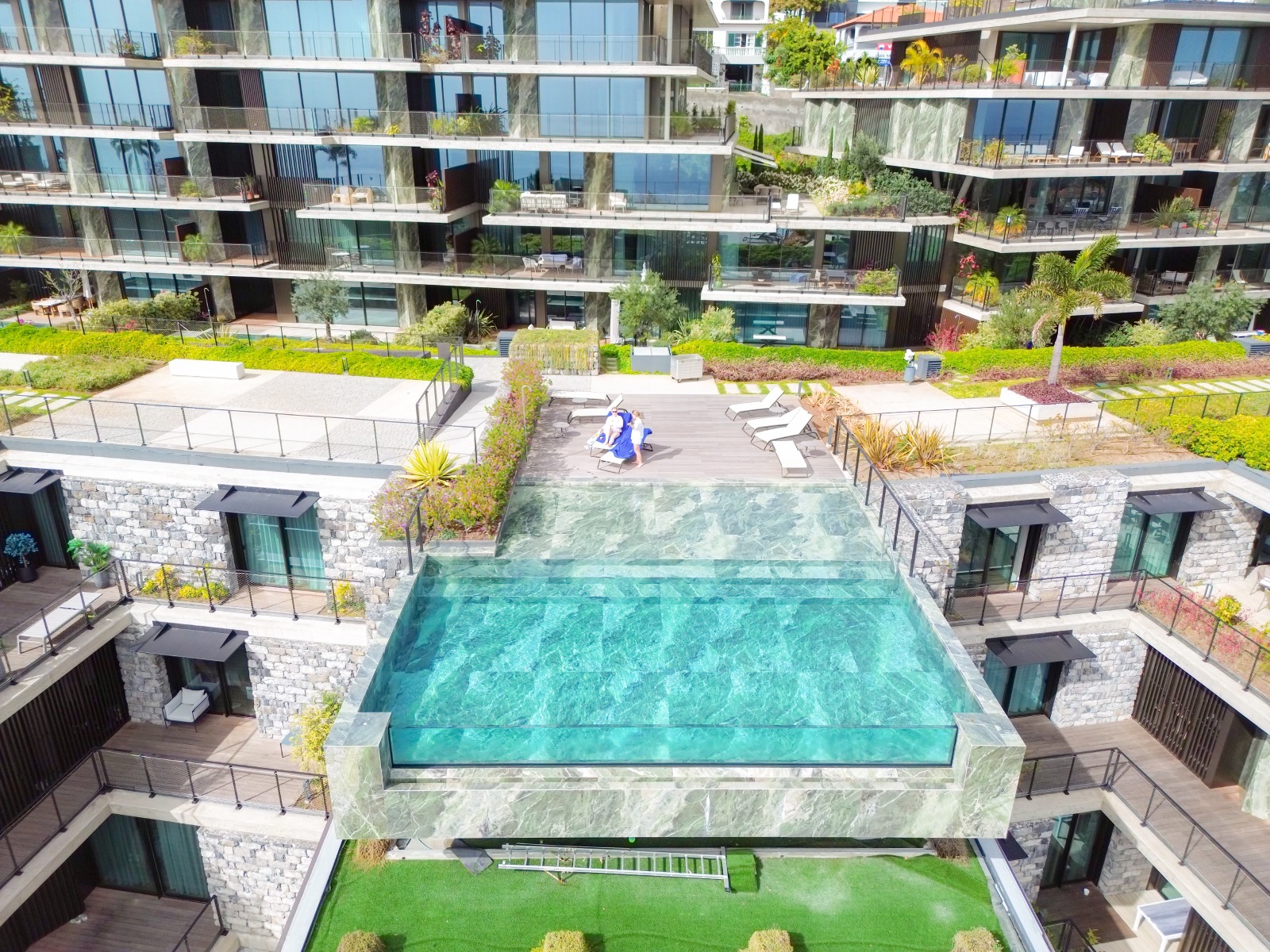 Aerial view of the infinity pool and buildings of Savoy Residence Monumentalis, São Martinho, Funchal